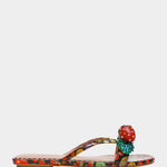 Colorful sandal with a decorative strawberry on toe strap close-up