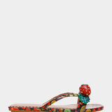 Colorful sandal with a decorative strawberry on toe strap close-up