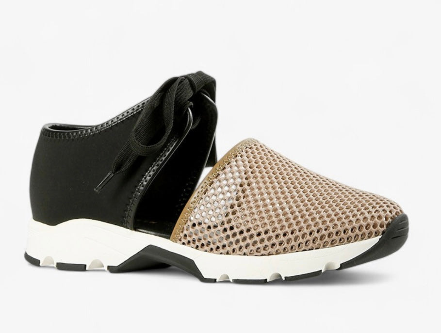 Black sneaker with beige mesh toe box with a white sole close-up