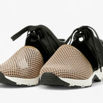Black sneaker with beige mesh toe box with a white sole pair