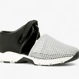 Black sneaker with gray mesh toe box with a white sole close-up