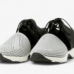 Black sneaker with gray mesh toe box with a white sole pair