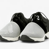 Black sneaker with gray mesh toe box with a white sole pair