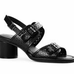 Black heel with decorative straps and buckle closure close-up