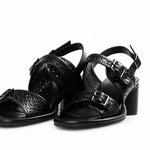 Black heel with decorative straps and buckle closure pair