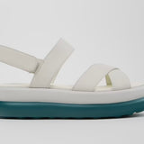 White platform sandal with a blue-green sole and multiple straps close up