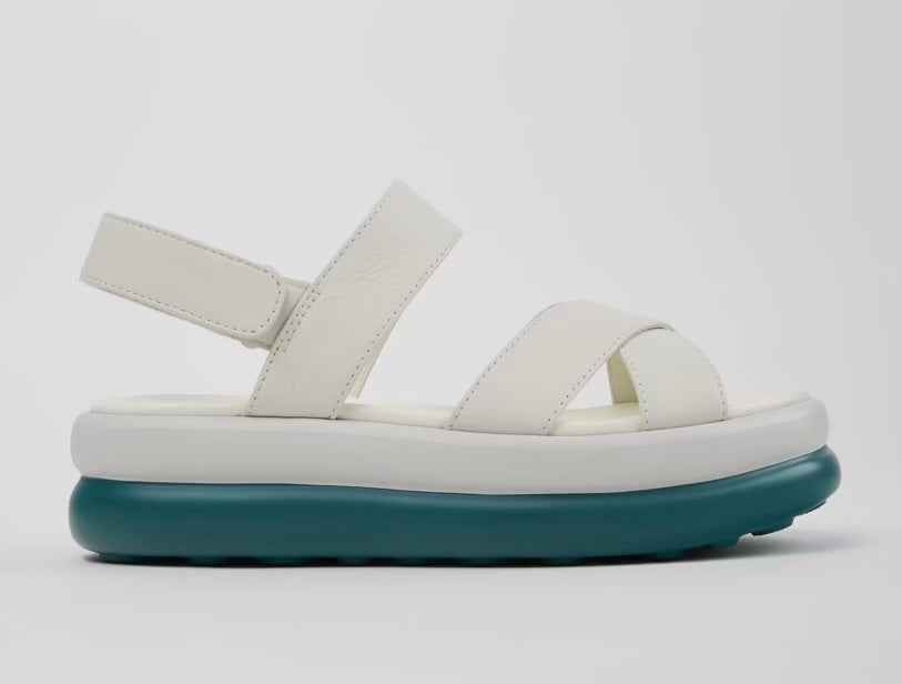 White platform sandal with a blue-green sole and multiple straps close up
