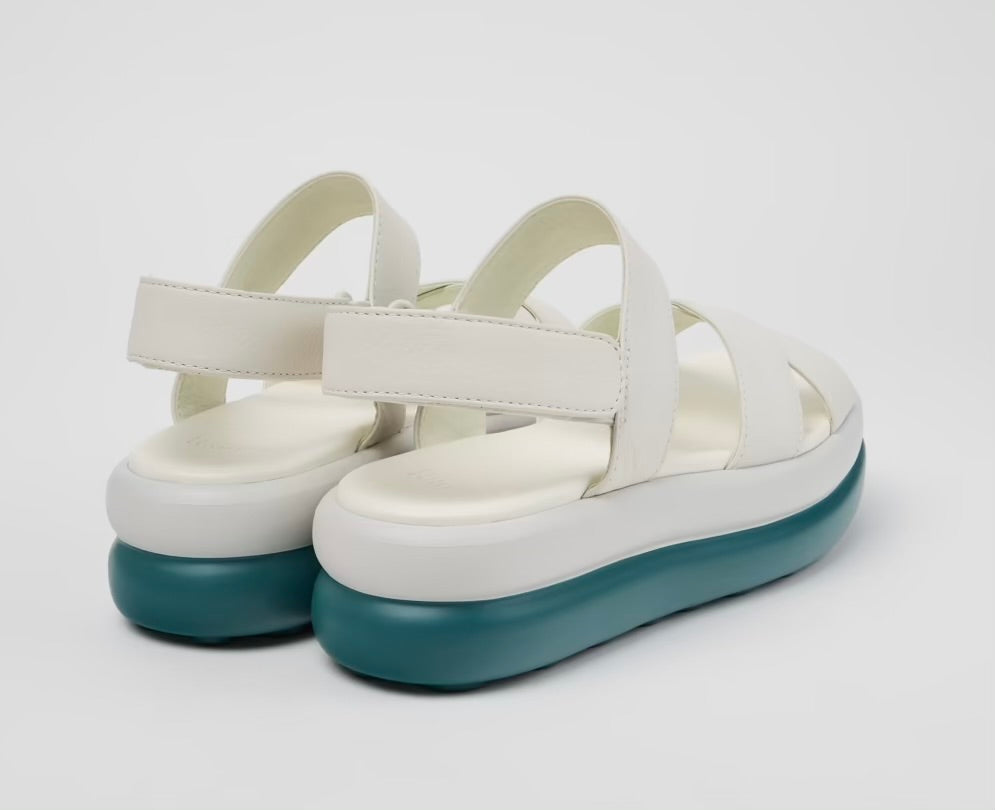 White platform sandal with a blue-green sole and multiple straps pair from back