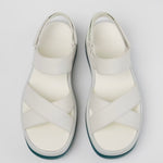 White platform sandal with a blue-green sole and multiple straps pair birds eye view