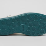 White platform sandal with a blue-green sole and multiple straps from bottom
