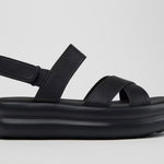 Black platform sandal with a thick sole and multiple straps close up