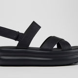 Black platform sandal with a thick sole and multiple straps close up