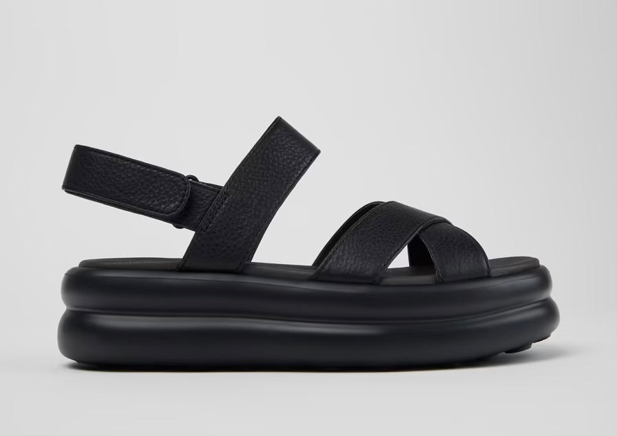 Black platform sandal with a thick sole and multiple straps close up