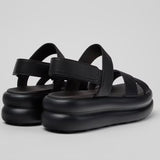 Black platform sandal with a thick sole and multiple straps pair from back