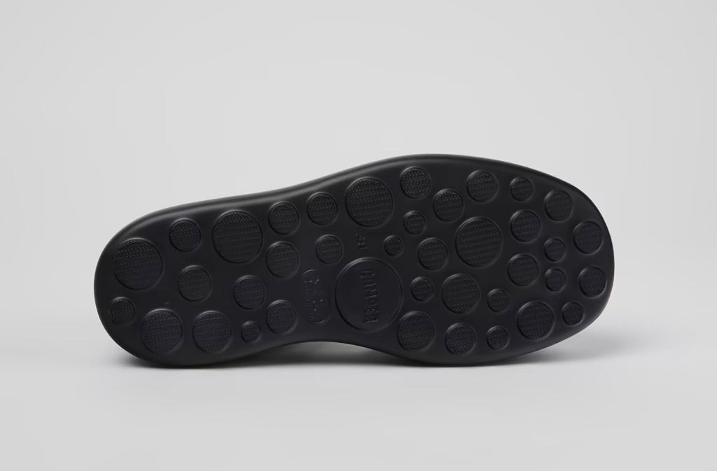 Black platform sandal with a thick sole and multiple straps bottom
