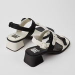 Black and white modern sandal with a block heel and buckle straps pair from back