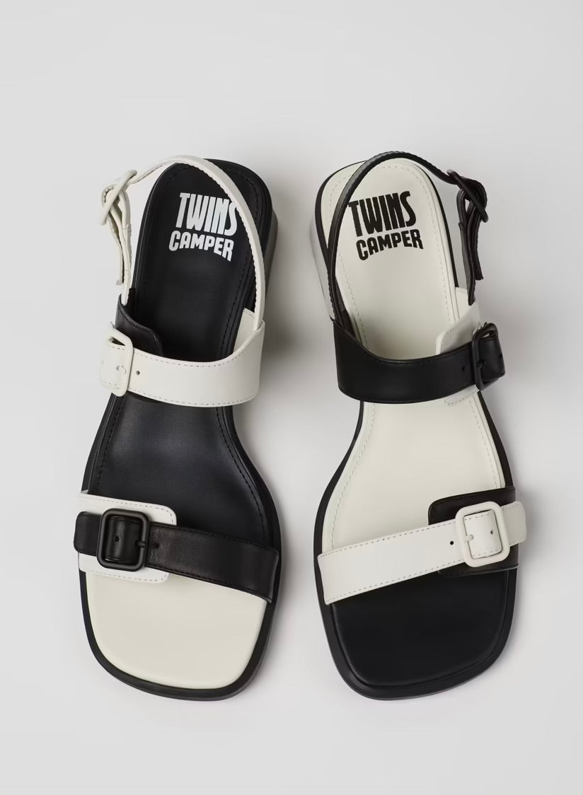 Black and white modern sandal with a block heel and buckle straps pair from top