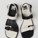 Black and white modern sandal with a block heel and buckle straps pair from top