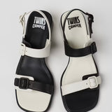 Black and white modern sandal with a block heel and buckle straps pair from top