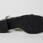 Black and white modern sandal with a block heel and buckle straps bottom