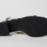 Black and white modern sandal with a block heel and buckle straps bottom