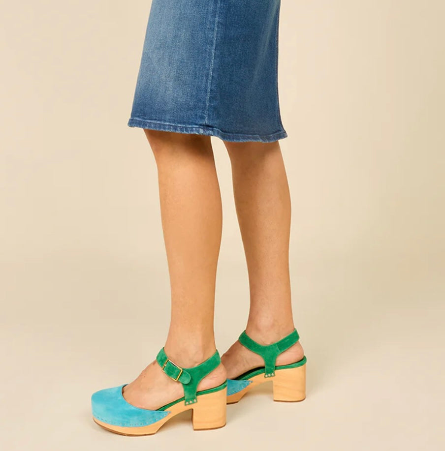 Green and blue suede shoe with golden buckle and wooden heel pair on model standing 