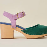 Green and blue suede clog shoe with pink strap with gold strap, and wooden sole close up