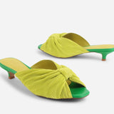 Yellow pleated kitten pen back sandal with a green heel pair front and back view