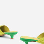 Yellow pleated kitten pen back sandal with a green heel pair close up on heel