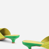Yellow pleated kitten pen back sandal with a green heel pair close up on heel