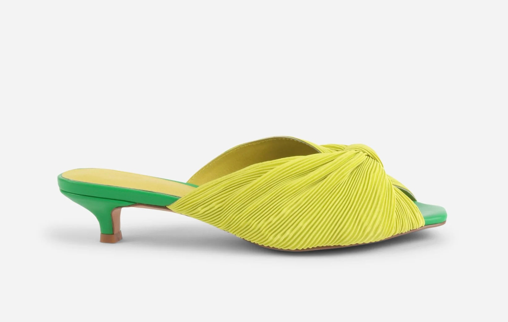 Yellow pleated kitten pen back sandal with a green heel close up