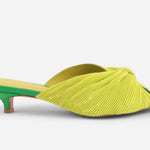 Yellow pleated kitten pen back sandal with a green heel close up