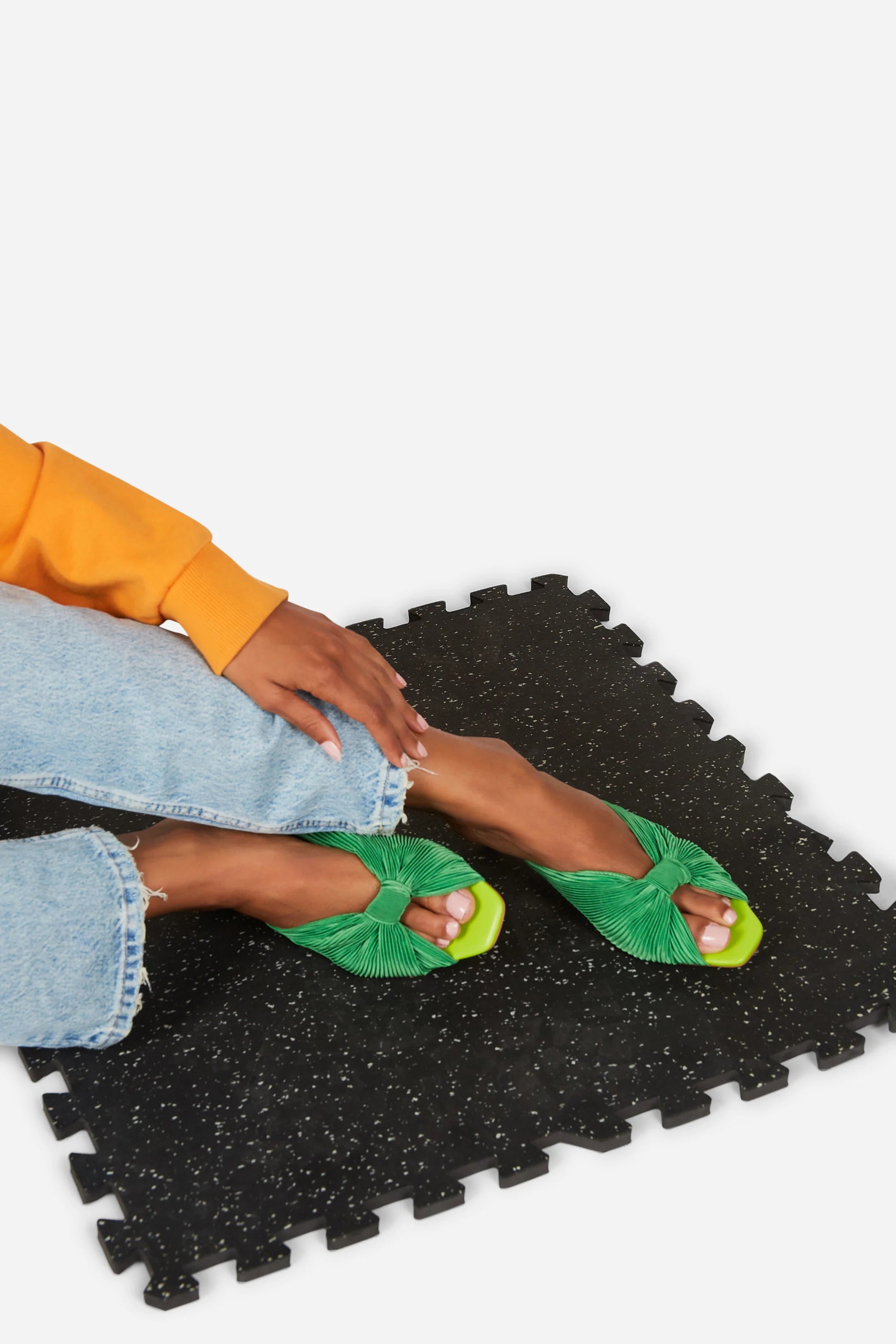Green pleated kitten heel with open back pair on model