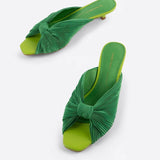 Green pleated kitten heel with open back pair from front side