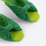 Green pleated kitten heel with open back pair close up front