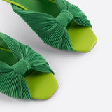 Green pleated kitten heel with open back pair close up front