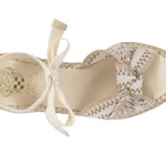 Beige sandal with woven design and bow on a white background