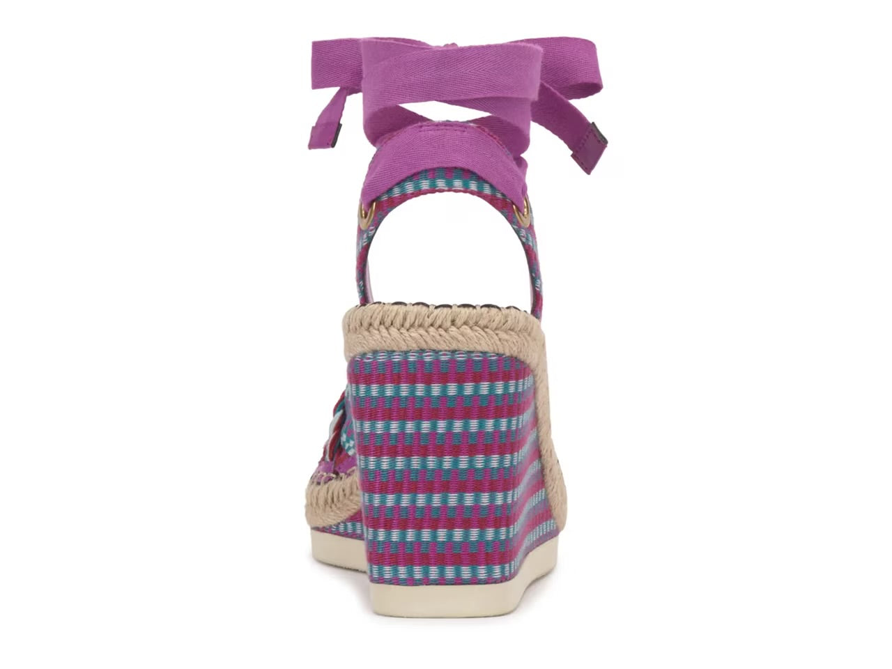 Woven wedge sandal with colorful pattern and purple bow on a white background