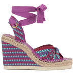Woven wedge sandal with a purple strap on a white background