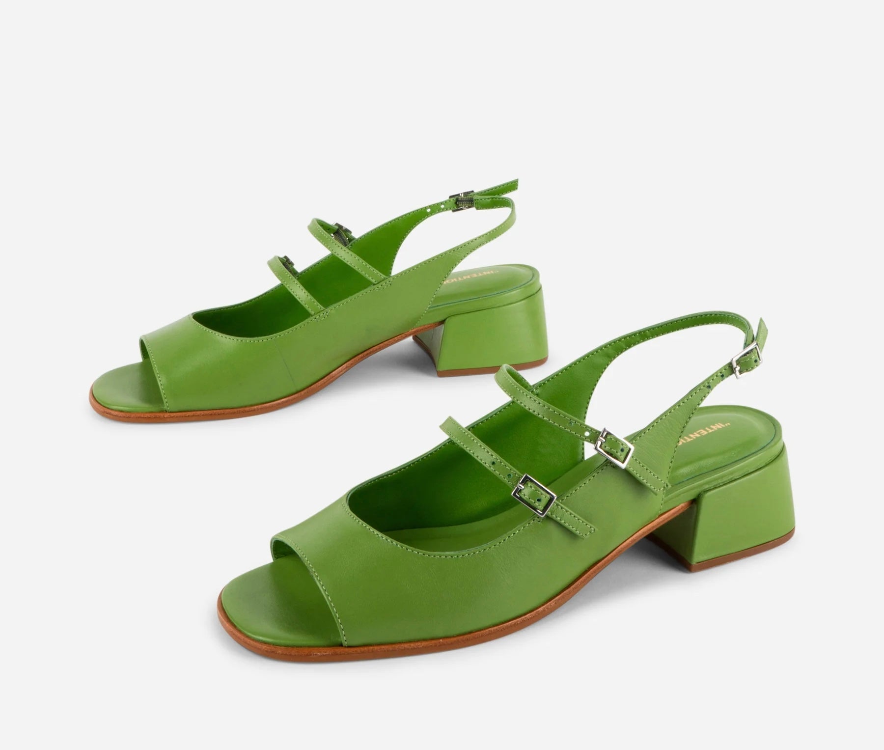 Green high-heeled sandals on a white background