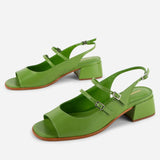 Green high-heeled sandals on a white background