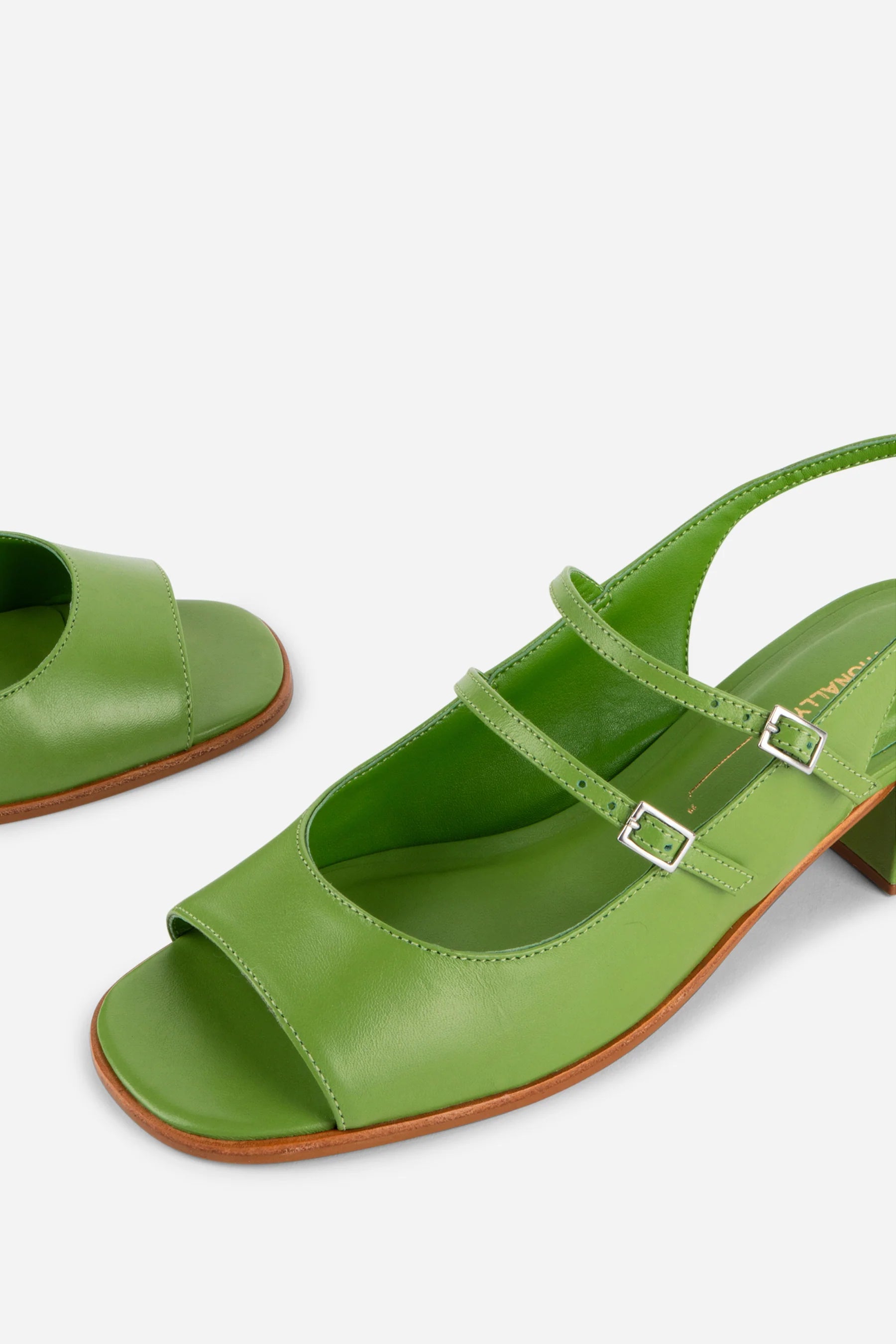 Green sandals with a strap on a white background