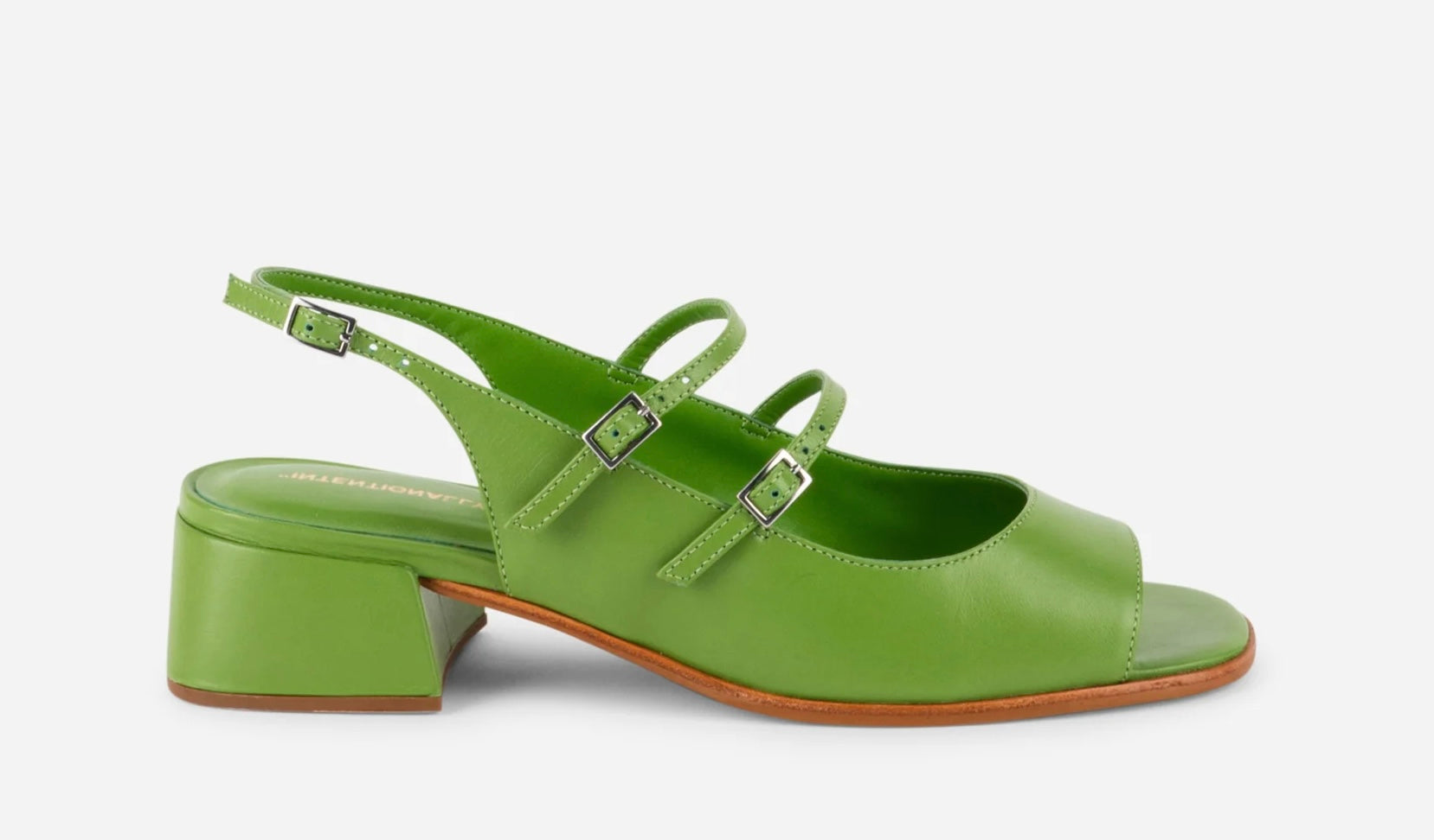 Green sandal with a block heel on a white background