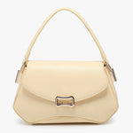 Beige handbag with a gold clasp close-up