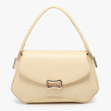 Beige handbag with a gold clasp close-up