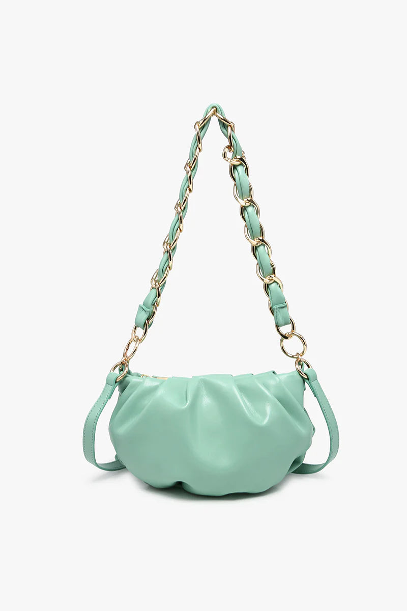 Mint green handbag with a chain strap close-up