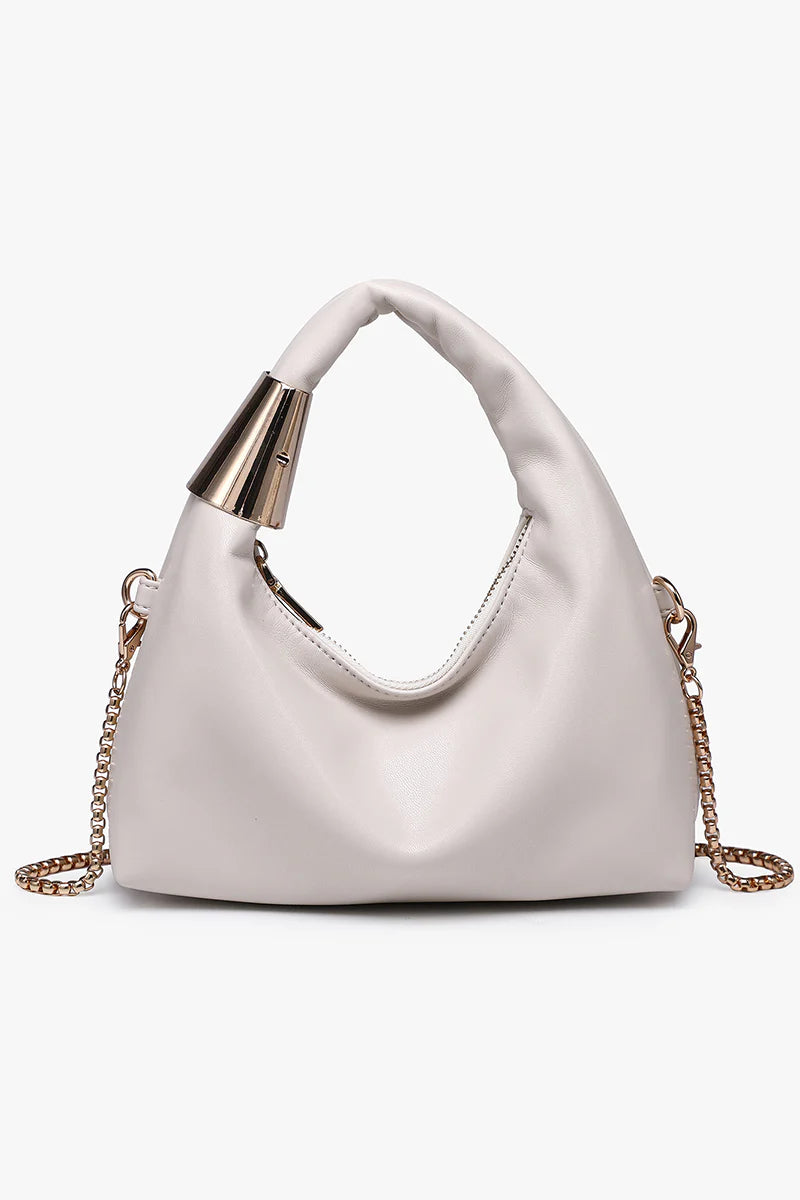 White handbag with gold chain and handle close-up