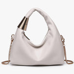 White handbag with gold chain and handle close-up