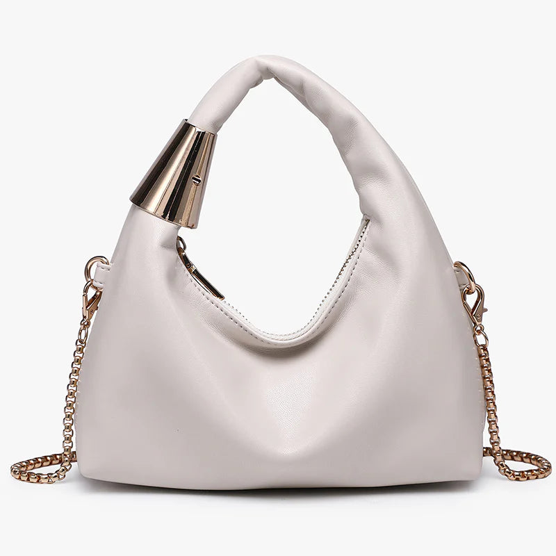 White handbag with gold chain and handle close-up