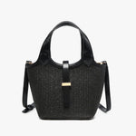 Black woven handbag with leather straps close-up